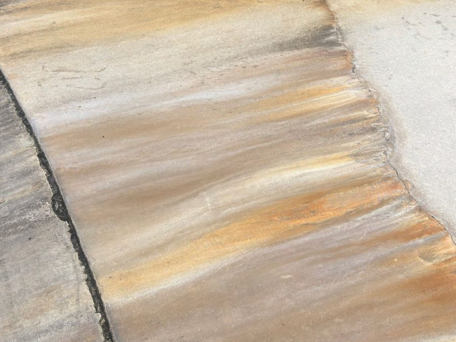 Rust or fertilizer stain on a concrete driveway