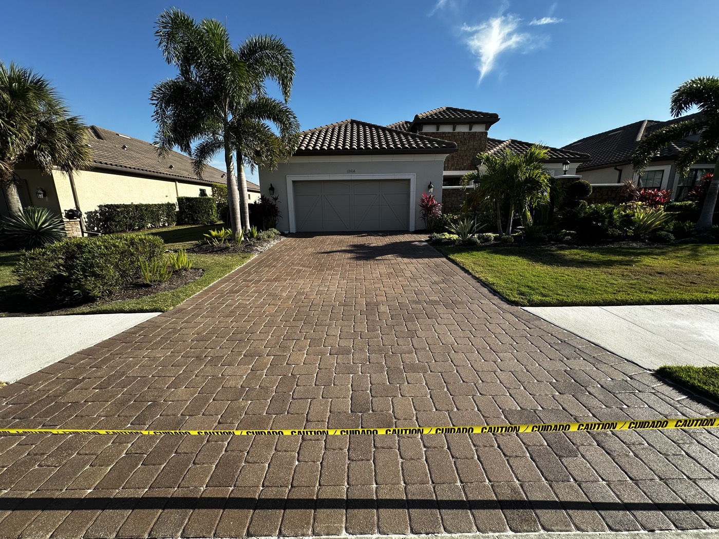 Same Esplanada driveway after cleaning and resealing, with rich brown paver color restored