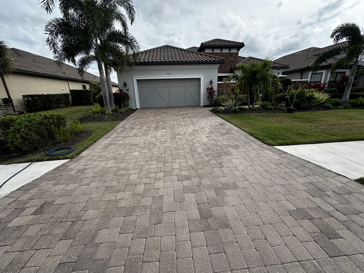 Faded, chalky-looking paver driveway in Esplanada before cleaning and resealing