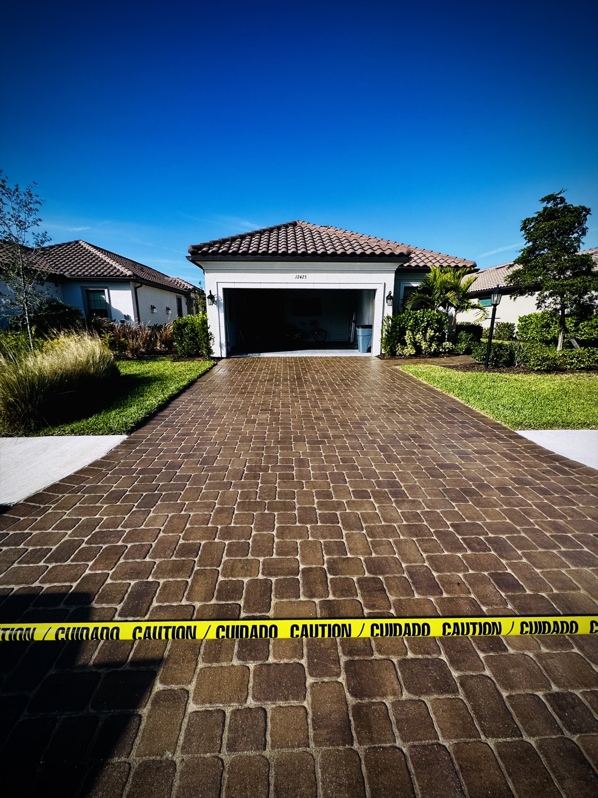 Freshly sealed paver driveway in Esplanada, Sarasota, with a deep wet-look sheen