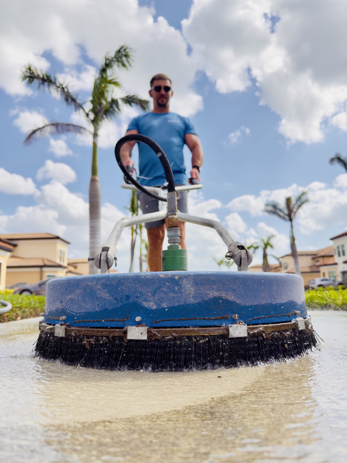 Rotary surface cleaner attachment pressure washing a sidewalk