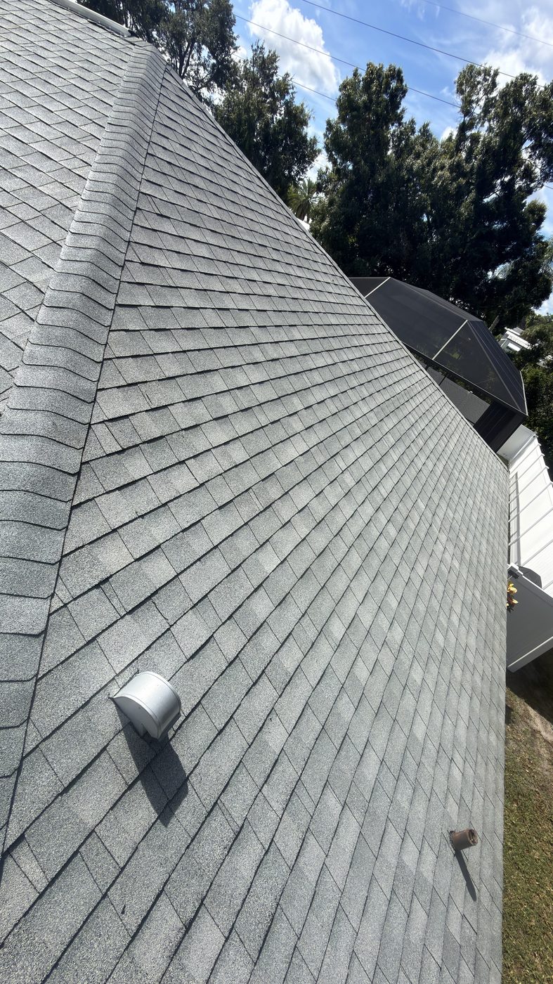Same asphalt shingle roof after soft washing, restored to a uniform gray