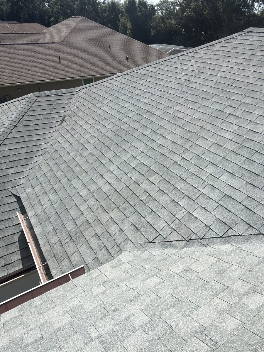 Same asphalt shingle roof after soft washing, algae streaks fully removed