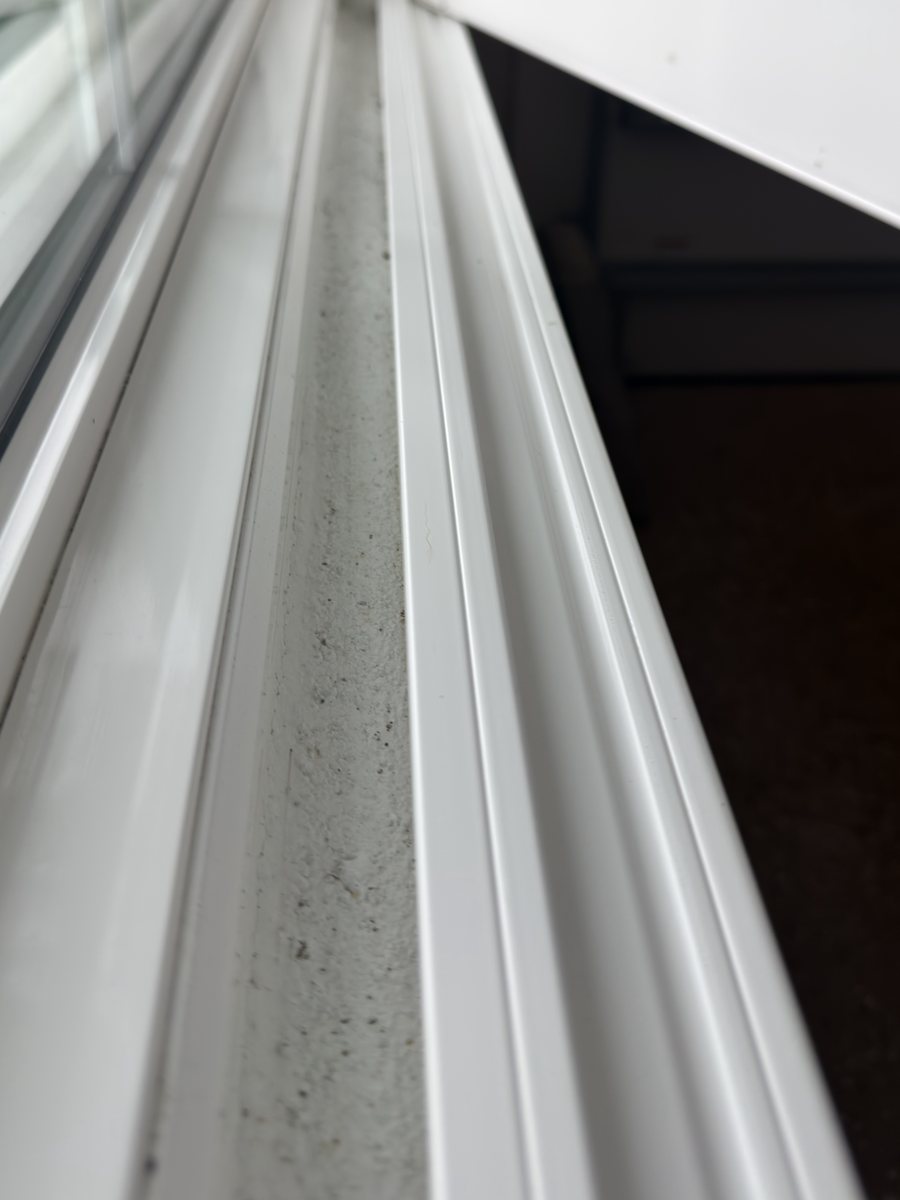 The same style of window track after cleaning, with the debris cleared out