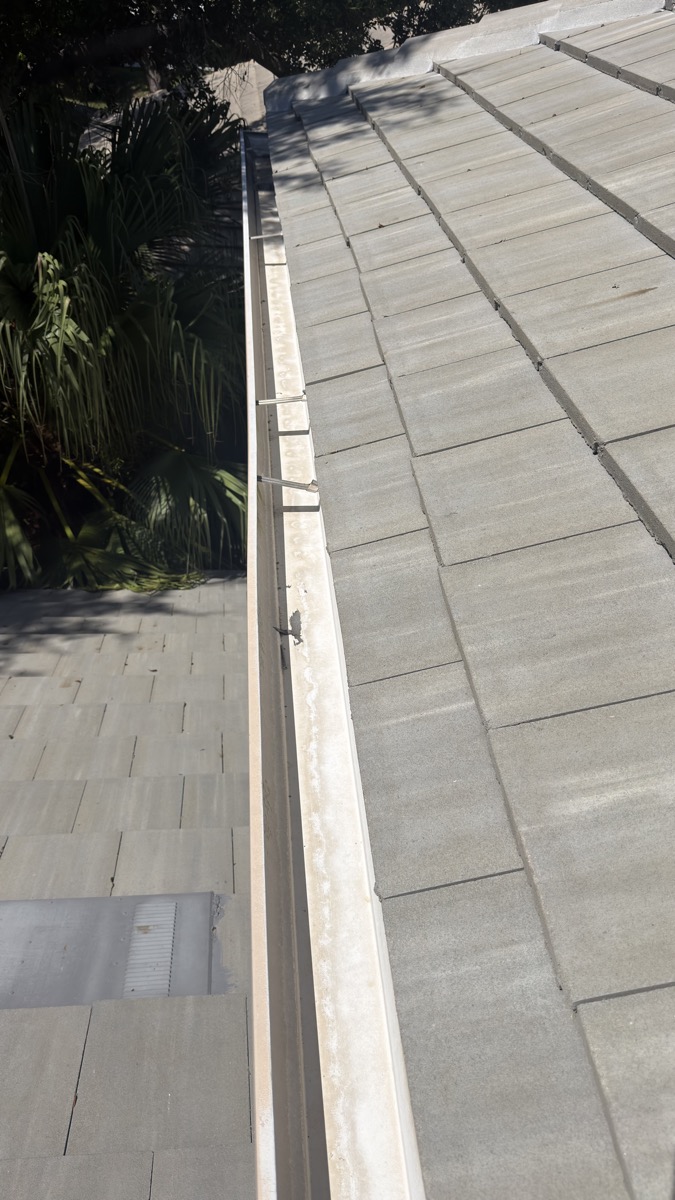 Same gutter, clean and debris-free after cleaning