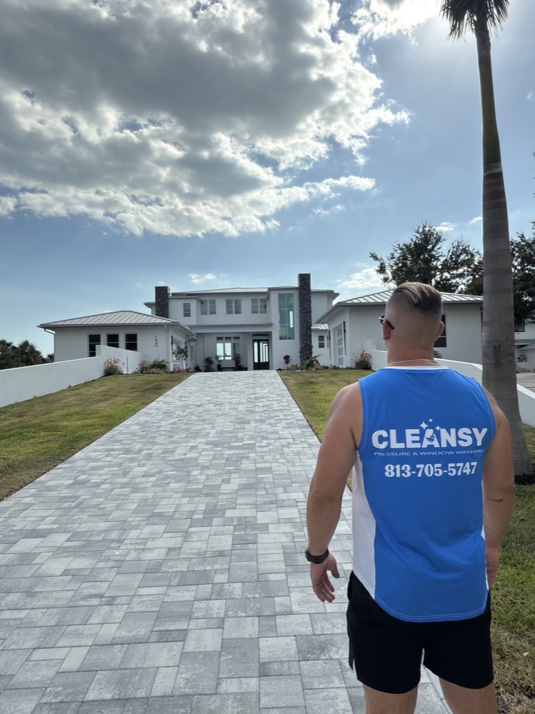 Cleansy branded shirt in front of a freshly washed Sarasota home
