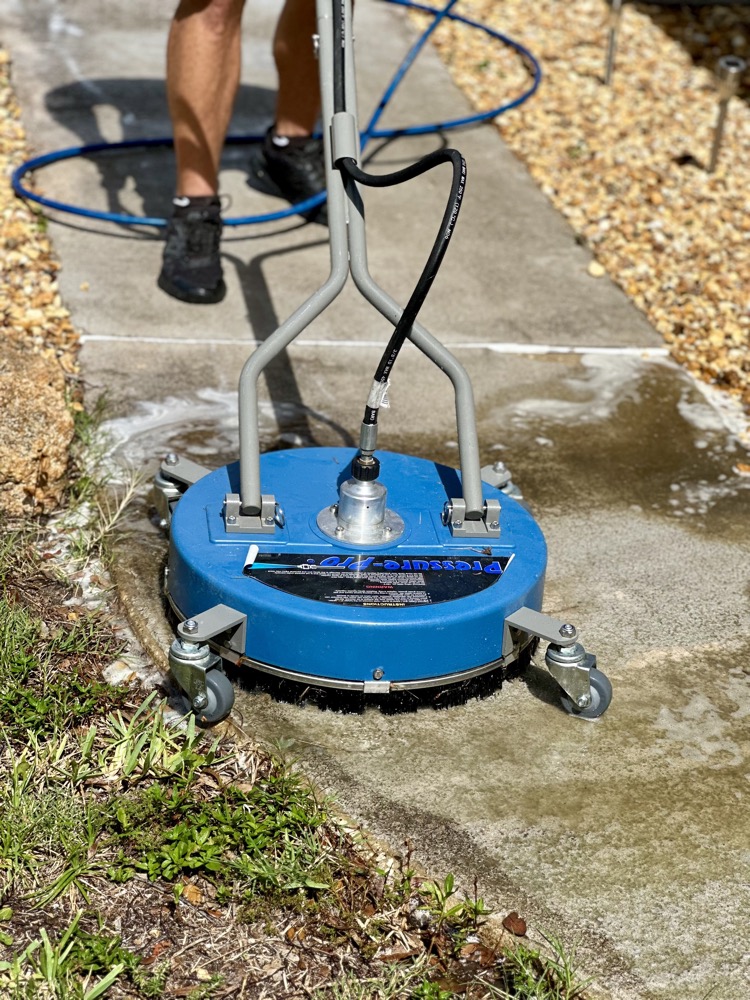 Pressure washing a concrete driveway with a surface cleaner attachment